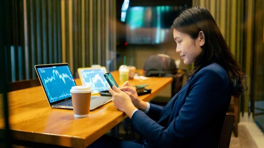 Happy young female stock-picker in a cafe