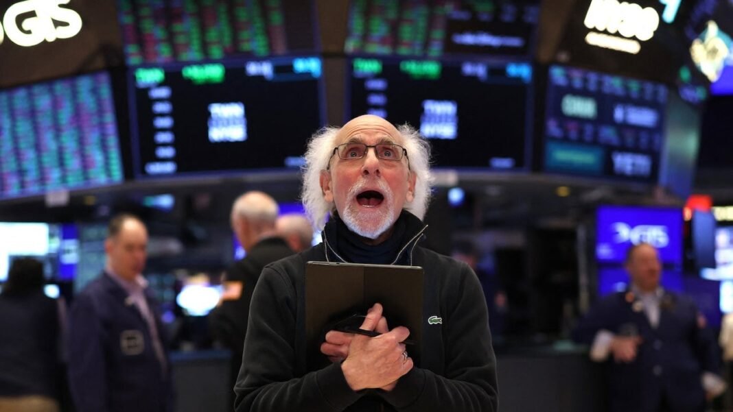 Trader Peter Michael Tuchman reacts as he works on the floor of the New York Stock Exchange (NYSE)