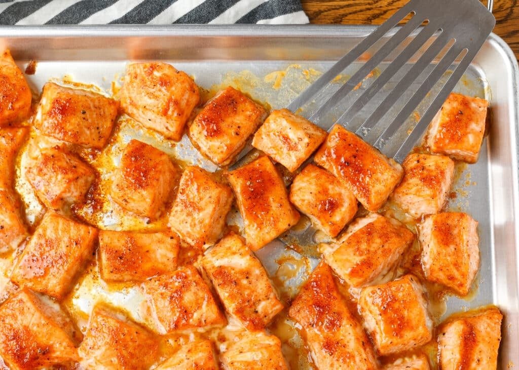 salmon bites with spatula on sheet pan