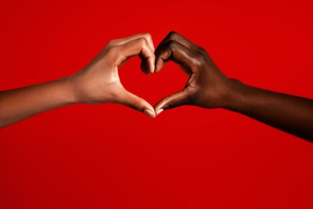 The FTSE 250 lags behind the FTSE 100, but we're Two multiracial girls making heart sign against red background
