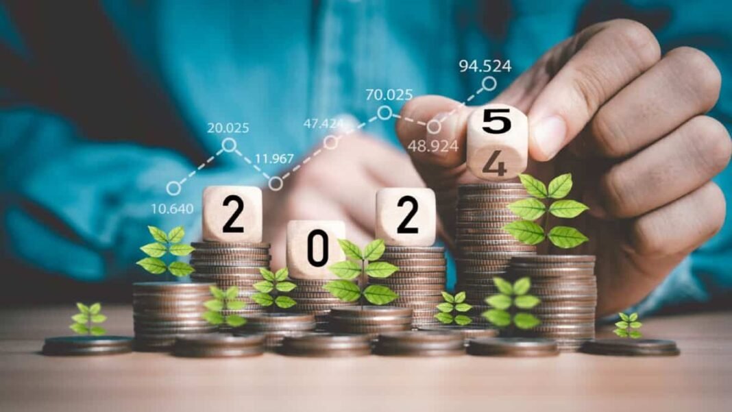 Businessman hand flipping wooden block cube from 2024 to 2025 on coins