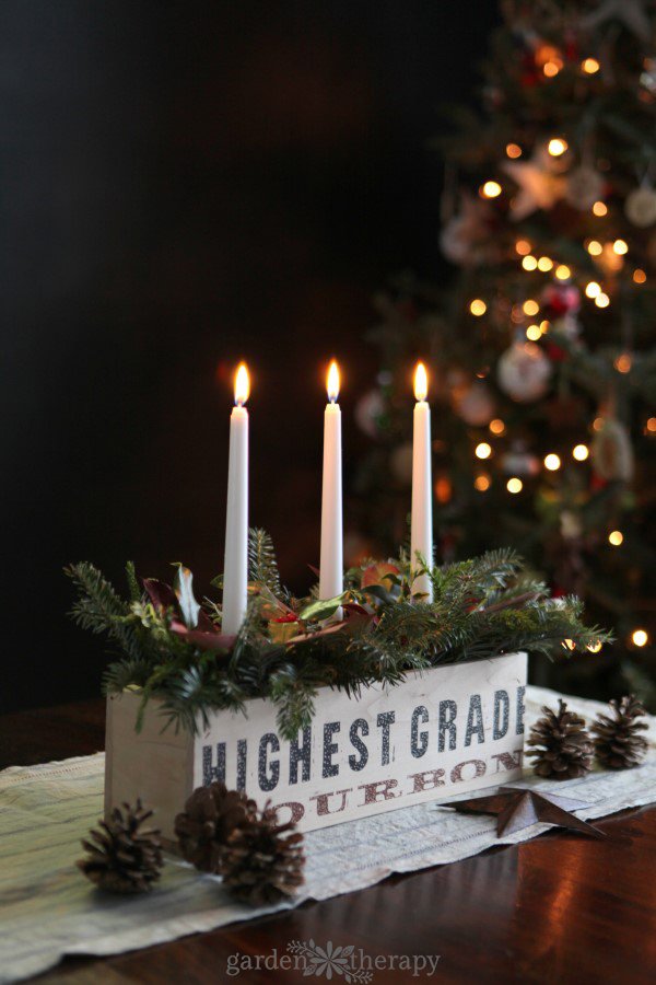 Rustic-and-Natural-Christmas-Candle-Centerpiece-1.jpg Lit candle centerpiece in a wood box with fresh greenery