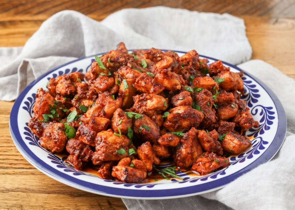 A horizontally aligned photo of a plate full of crispy, juicy southwest chicken bites.