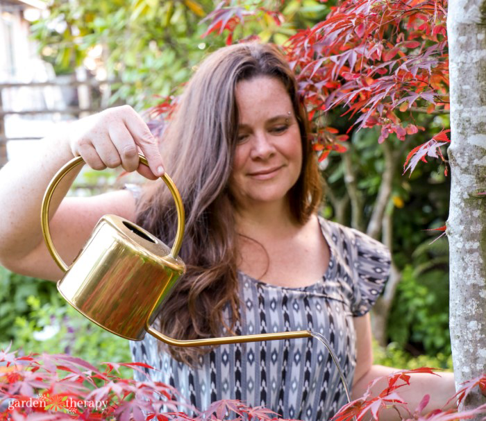 Woman with watering can filled with conserved water