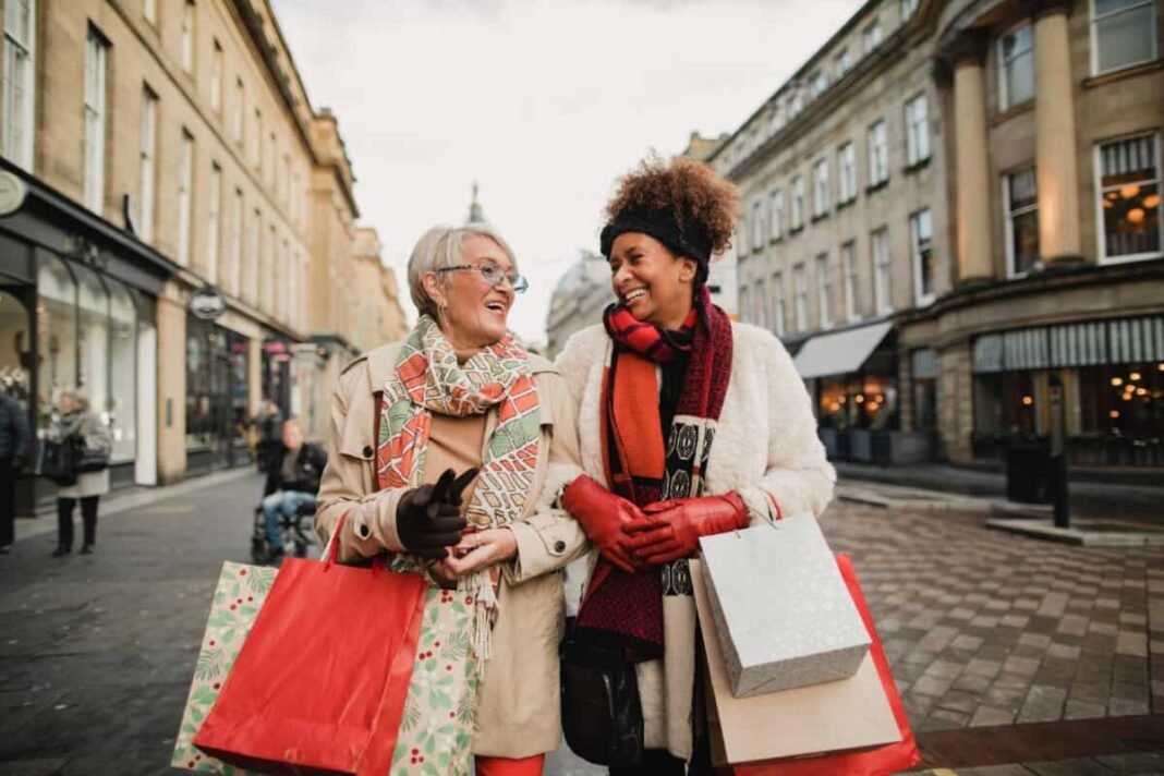 2 very cheap stocks to consider buying today Two female adult friends walking through the city streets at Christmas. They are talking and smiling as they do some Christmas shopping.