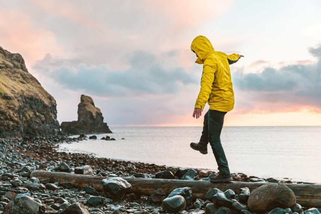 Are Barclays shares trading at a 50% discount? Man hanging in the balance over a log at seaside in Scotland