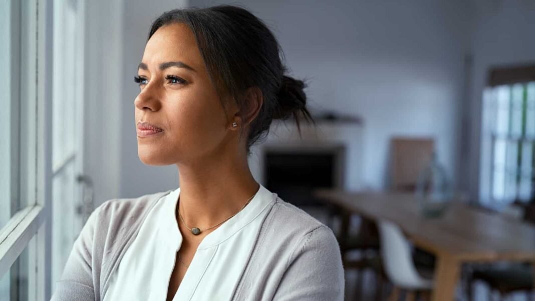 With stock market risks emerging, is it time to consider Young mixed-race woman looking out of the window with a look of consternation on her face