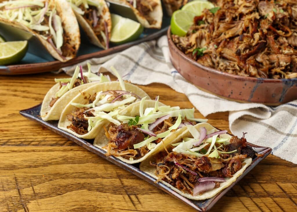 Carnitas-Street-Tacos-BFK-5-1024x731.jpg Pork carnita tacos on platter on wooden table