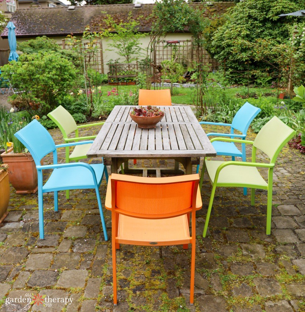 Colourful-patio-chairs.jpg Colourful patio chairs around outdoor dining table