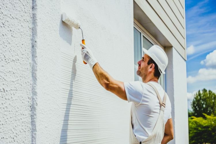 How does surface temperature affect exterior paint adhesion and Curing