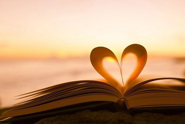 kindness_quotes_1.jpg A heart made of two pages in an open book with a sunrise on the horizon.