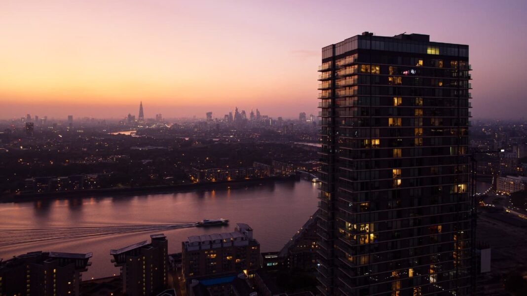 3 UK stocks to consider buying and holding for 10 Elevated view over city of London skyline