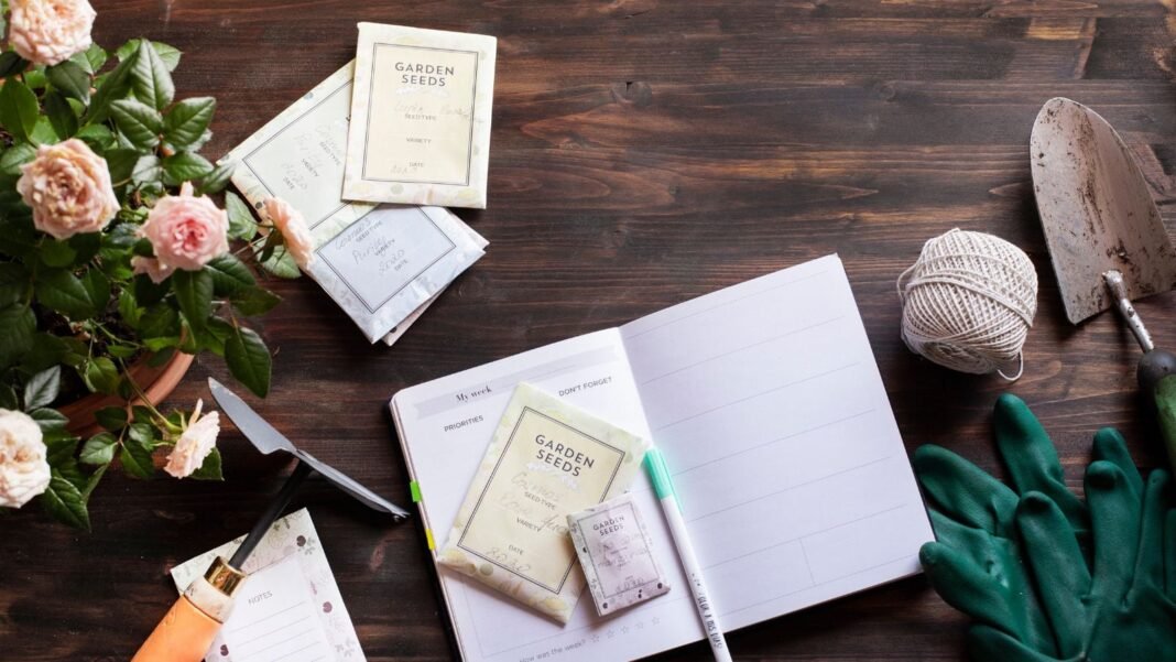 A close-up and overhead shot of several tools, equipment, seeds, and a notebook, showcasing mom gardening gifts