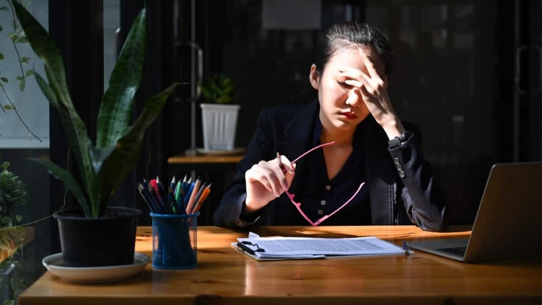 My favorite UK stocks have just plummeted 19% - are Young Asian woman with head in hands at her desk