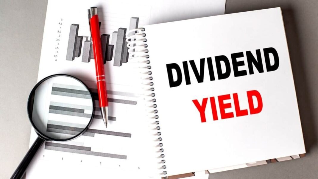 Witnessing the powerful dividend power of Lloyds shares... DIVIDEND YIELD text written on a notebook with chart