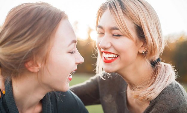 funny_august_quotes.jpg Two women laughing outdoors in the sun.