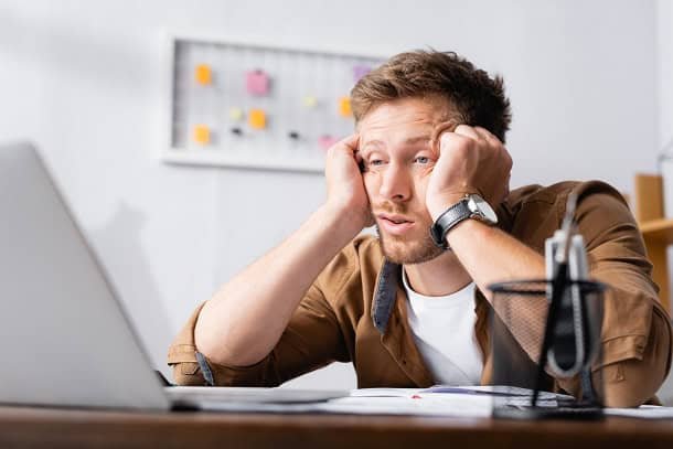 lost_your_motivation_2024.jpg A man sitting in front of his laptop looking tired and unmotivated.