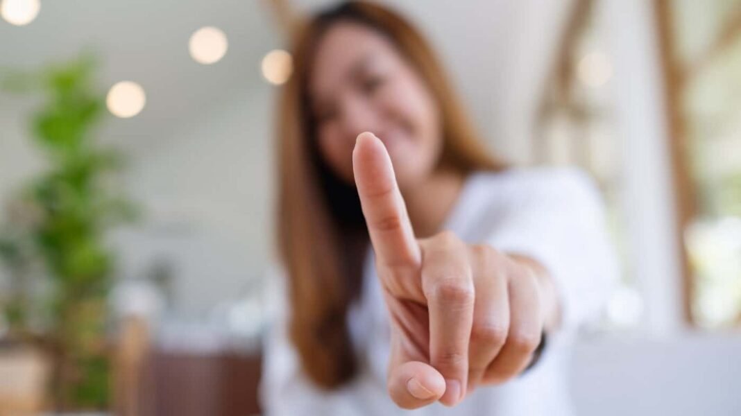 Could the market crash be a once-in-a-decade opportunity to buy A young Asian woman holding up her index finger